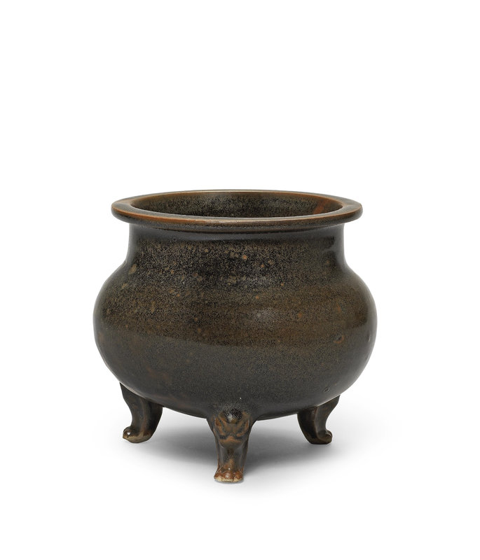 A black and russet-glazed globular tripod incense burner, Tang Dynasty (618-907)