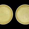 A rare pair of large yellow-glazed 'crane' dishes, <b>Incised</b> Jiajing six-character marks and of the period