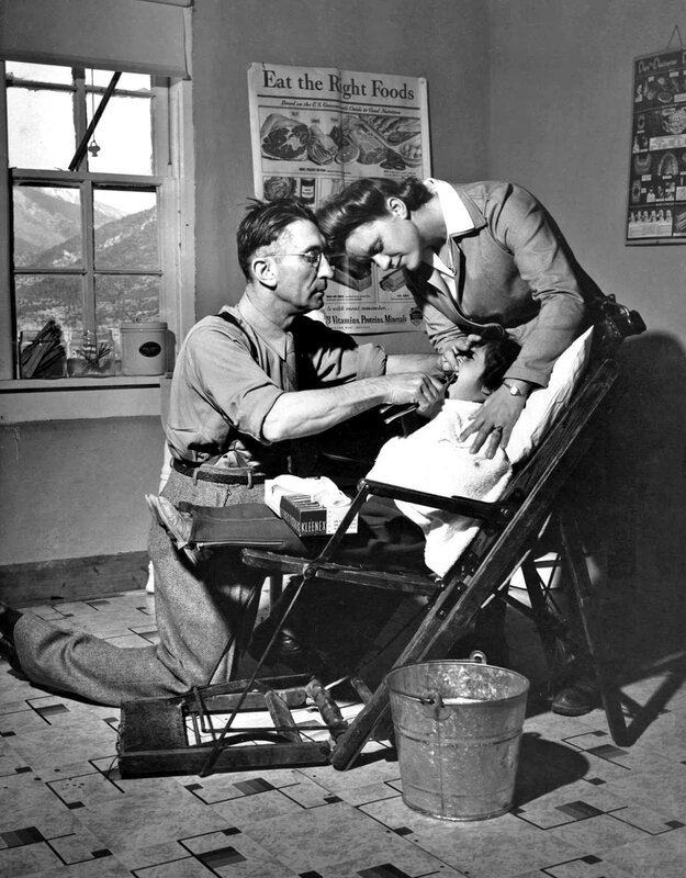 John Collier - Dentist making an extraction in the clinic operated by the Taos County cooperative health association