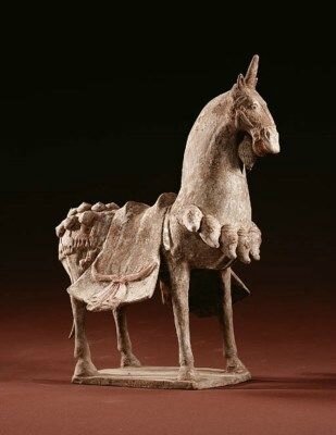 A painted buff pottery figure of a caparisoned horse, Northern Wei Dynasty (386-534)