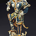 A large sancai and <b>blue</b>-<b>glazed</b> <b>pottery</b> figure of a lokapala, Tang dynasty (AD 618-907)