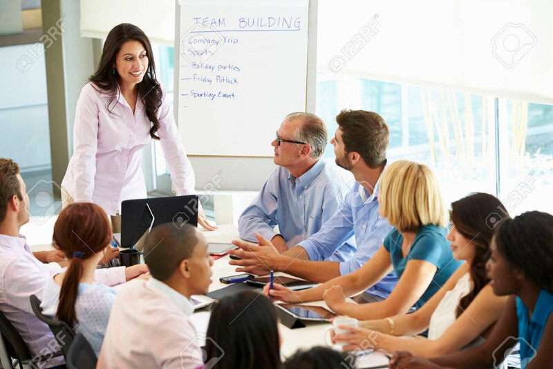 31047567-businesswoman-addressing-meeting-around-boardroom-table
