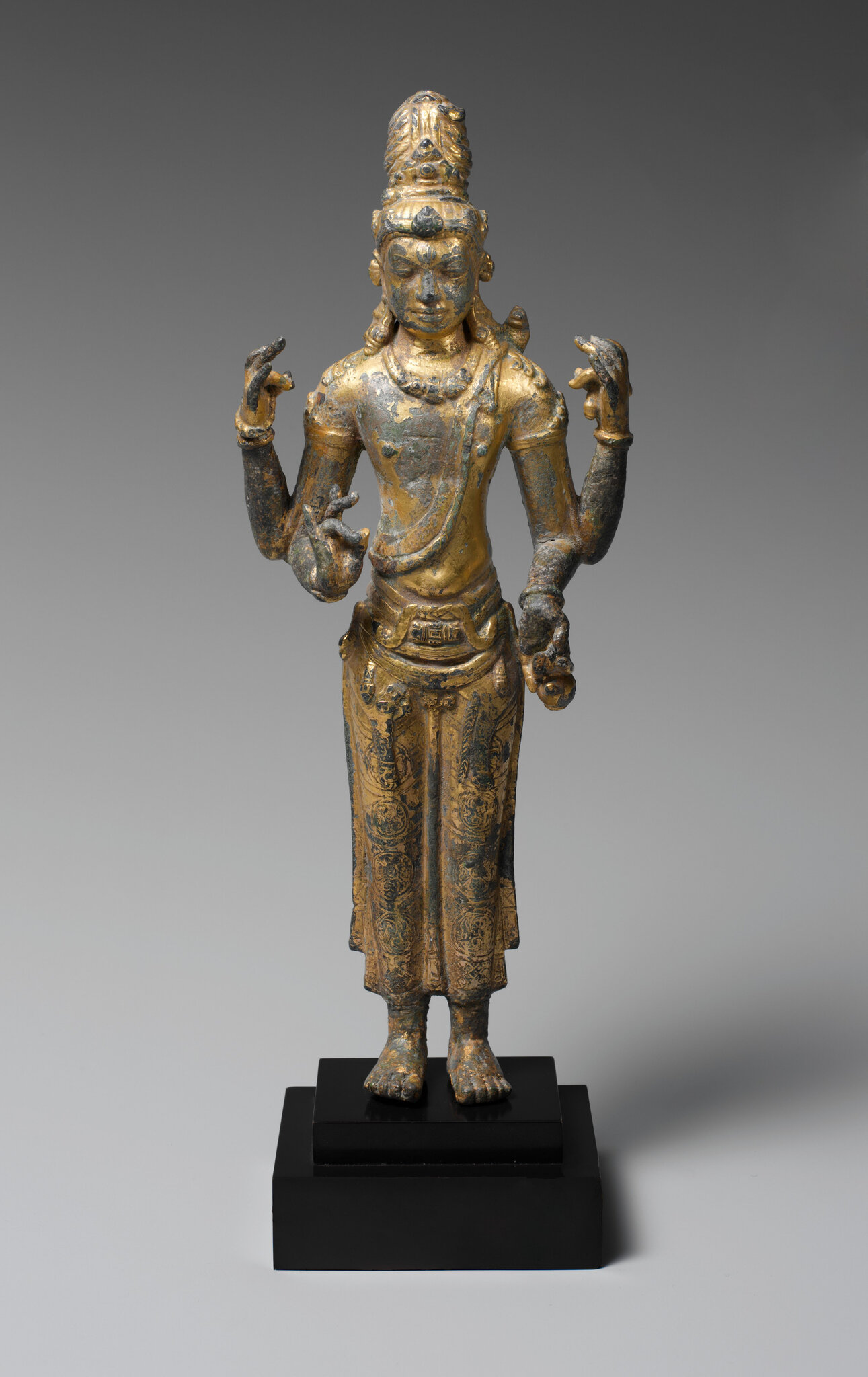 The “Luck of Yunnan”. A rare gilt-bronze standing figure of