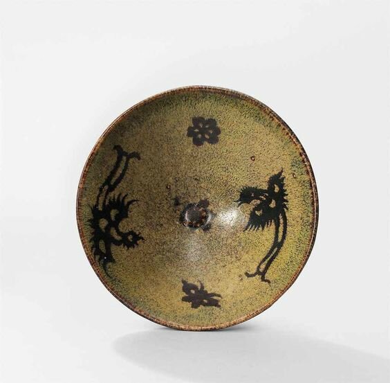 A Jizhou 'phoenix and prunus' paper-cut resist-decorated tea bowl, Southern Song Dynasty (1127-1279)