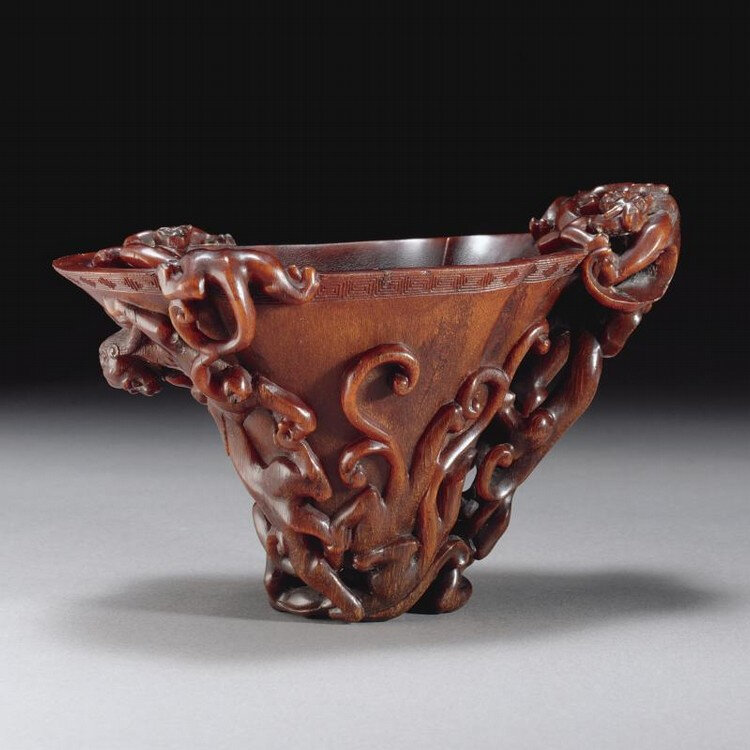 A magnificent Imperial rhinoceros horn 'nine dragon' libation cup, Qing dynasty, Kangxi period