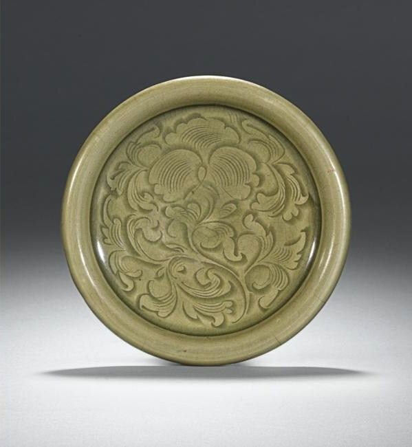 Lot 10. A rare carved yaozhou celadon dish, Northern Song Dynasty, 11th-12th century; 18.8cm., 7 3/8 in. Estimate 30,000—40,000 GBP. Lot Sold 73,250 GBP. Photo Sotheby's 2011

