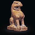 An <b>amber</b>-<b>colored</b> <b>stone</b> figure of a seated lion, Northern Qi-Tang dynasty (AD 550-907)