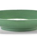 A very fine <b>melon</b>-<b>green</b> <b>glazed</b> imperial saucer dish, China, Yongzheng six-character mark and of the period