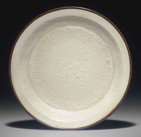 A molded Dingyao dish, Jin dynasty (1115-1234)