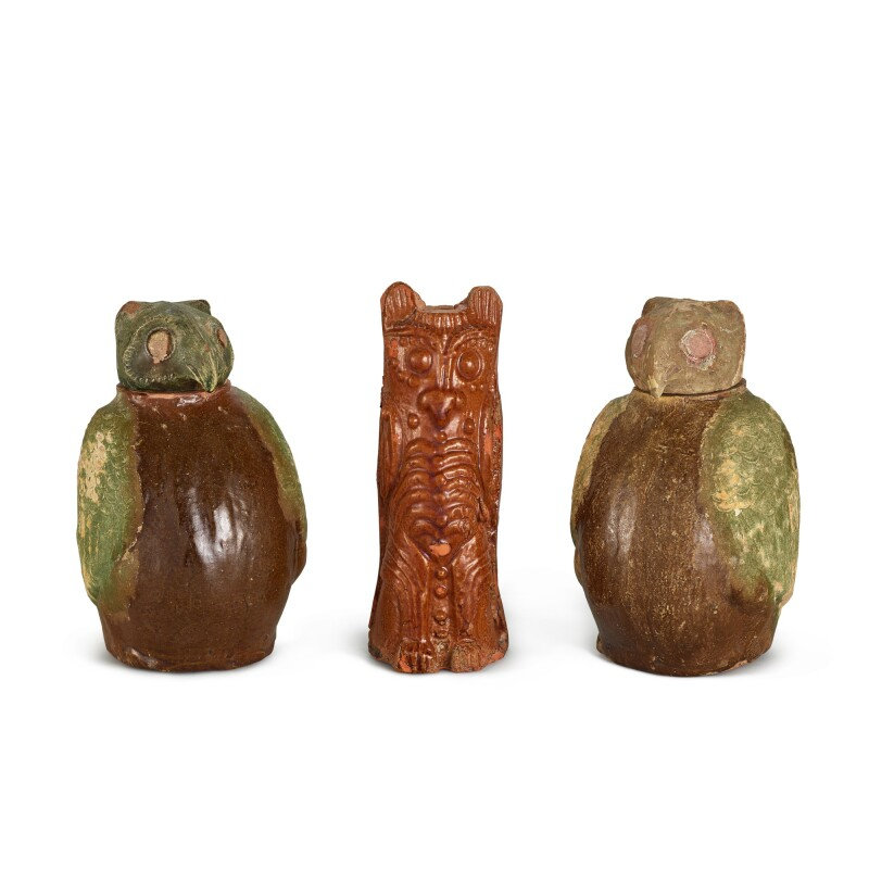 A pair of brown and green-glazed 'owl' jars and covers, and a brown-glazed pottery figure of an owl, Han dynasty