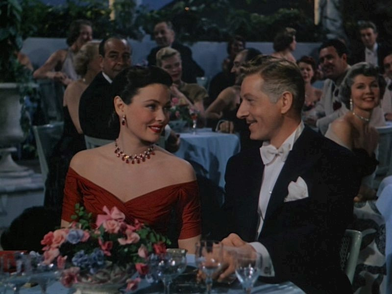 Oleg_Cassini-dress_red_purple_sash-gene_tierney-1951-on_the_riviera-cap-1