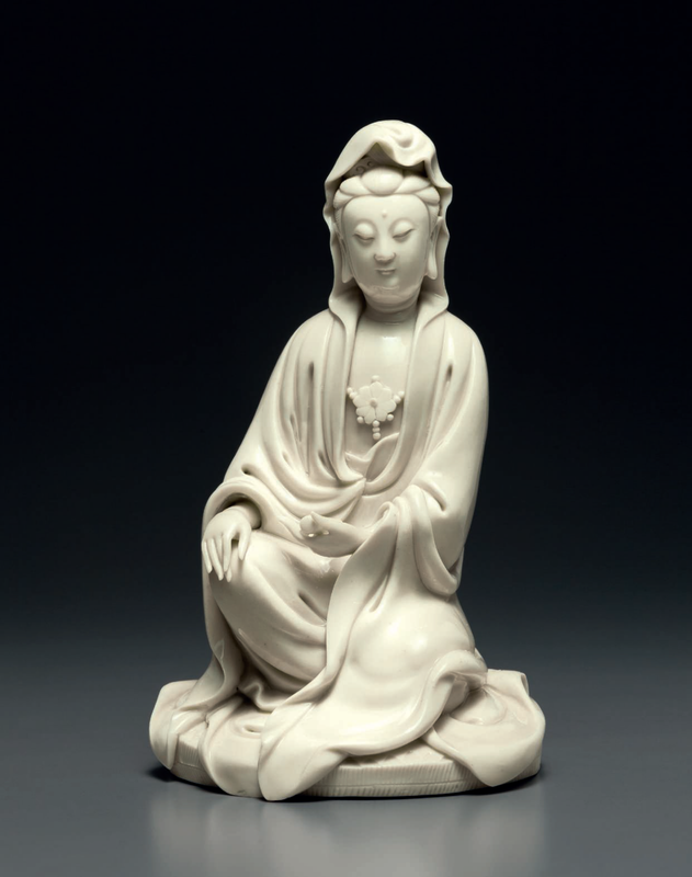 A Dehua figure of Guanyin with a scroll, Ming dynasty, early 17th century, impressed He Chaozong mark within a double gourd