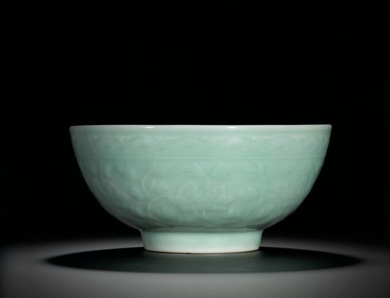 A fine large celadon-glazed bowl with carved and moulded peonies, Seal mark and period of Yongzheng (1723-1735)