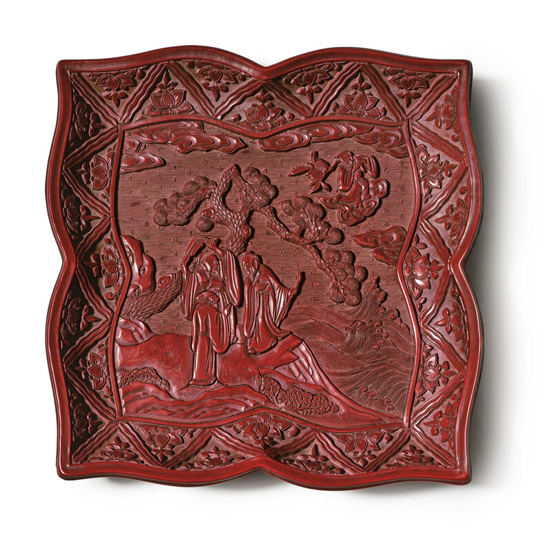 A rare and finely carved lacquer 'Immortals' quatrefoil tray, Ming dynasty, 16th century