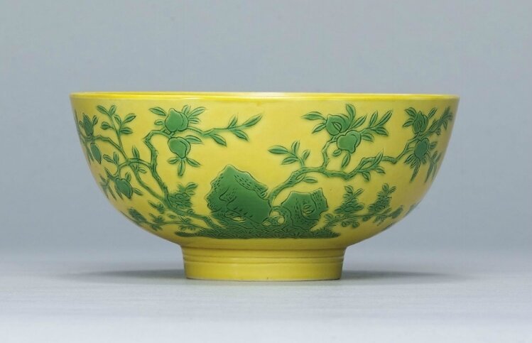 A rare incised yellow-ground green enamelled bowl,Yongzheng six-character mark within a double circle in aubergine enamel and of the period (1723-1735)