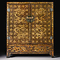 A large Chinese <b>brown</b>-<b>ground</b> <b>and</b> <b>gilt</b>-<b>decorated</b> <b>lacquer</b> cabinet (gui), Ming dynasty, Wanli period <b>and</b> later