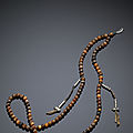 A strand of rhinoceros horn <b>Tibetan</b> rosary beads, Qing dynasty, 19th century