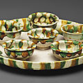 A sancai-glazed pottery <b>circular</b> <b>tray</b> <b>and</b> <b>six</b> <b>cups</b>, Tang dynasty (AD 618-907)
