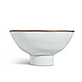 An exceptionally rare white-glazed 'Eight Buddhist Emblems' stem bowl, Mark and period of <b>Xuande</b> (1426-1435)