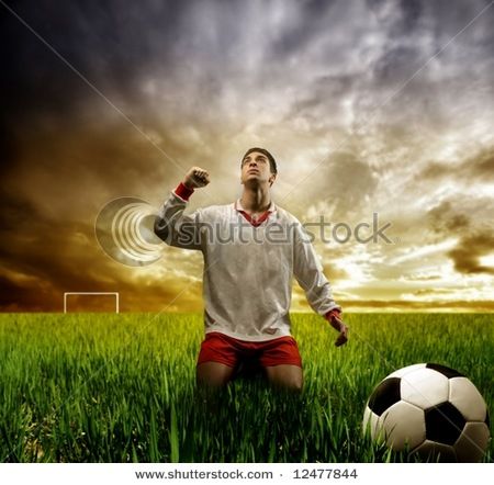 stock_photo_a_soccer_player_on_the_grass_field_12477844