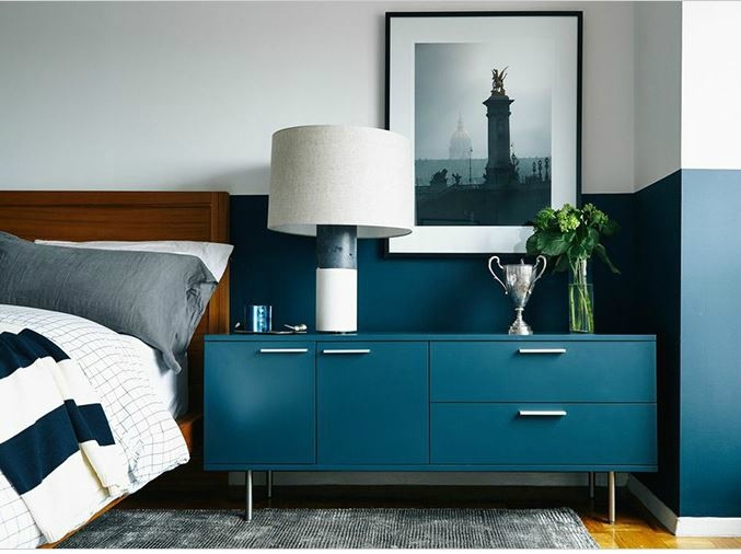 light-and-bright-bedroom-with-teal-dresser-and-matching-colour-blocked-wall-in-teal