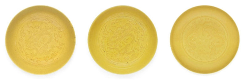 Three yellow-glazed incised 'dragon' saucer-dishes, Daoguang marks and of the period & Guangxu mark and of the period