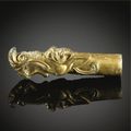 A gilt-bronze '<b>dragon</b> <b>head</b>' fitting. Han dynasty