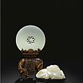 A white jade pierced disc with <b>boxwood</b> 'elephant' stand, Qing dynasty, 18th Century