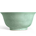 A fine and large celadon-glazed bowl carved with flower and fruit sprays, Seal mark and period of Qianlong (1736-1795)