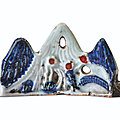 A blue and white and copper-red 'mountain' <b>brush</b>-<b>rest</b>, Ming dynasty, 17th century