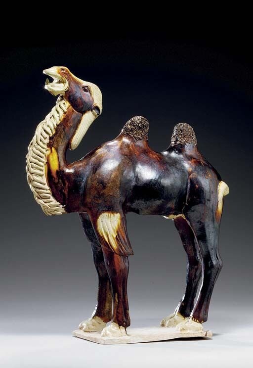 An_unusual_chestnut_and_straw_glazed_pottery_figure_of_a_Bactrian_camel__Tang_dynasty__618_907__