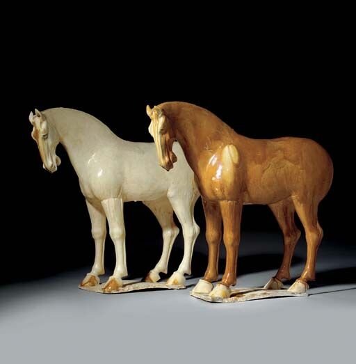 A_pair_of_large_amber_and_cream_glazed_pottery_figures_of_horses__Tang_dynasty__618_907__