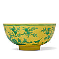 A rare yellow-ground green-enamelled 'Peach and Bird' bowl, Yongzheng six-character mark and <b>of</b> the period (1723-1735)