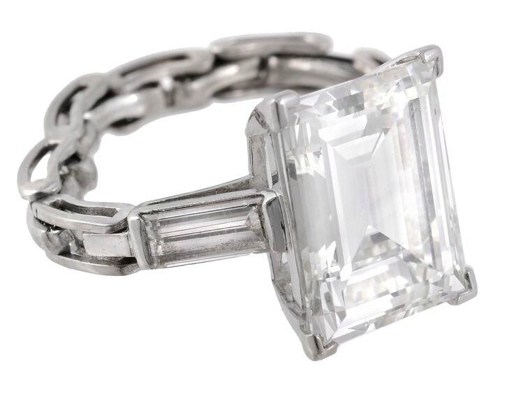 A diamond single stone ring, the rectangular step cut diamond
