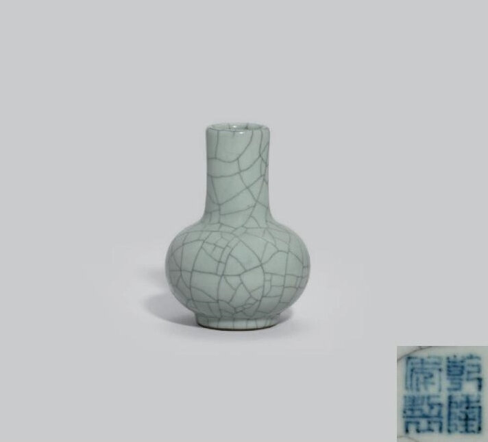 A small Guan-type bottle vase, Qianlong four-character seal mark in underglaze blue and of the period (1736-1795)