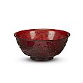 A Chinese <b>ruby</b> <b>glass</b> bowl, carved with birds among flowering branches, Four-character Qianlong mark and probably of the period 