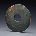 A large mottled <b>dark</b> <b>green</b> <b>jade</b> bi, Neolithic period, North-West China, circa 2000-1500 BC