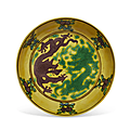 A small yellow-ground <b>aubergine</b> and green-enameled 'dragon' dish, Kangxi six-character mark and of the period