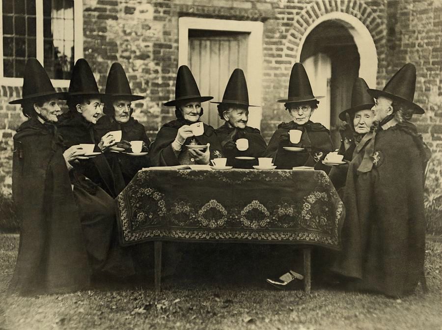eight-women-in-high-hats-having-tea-everett