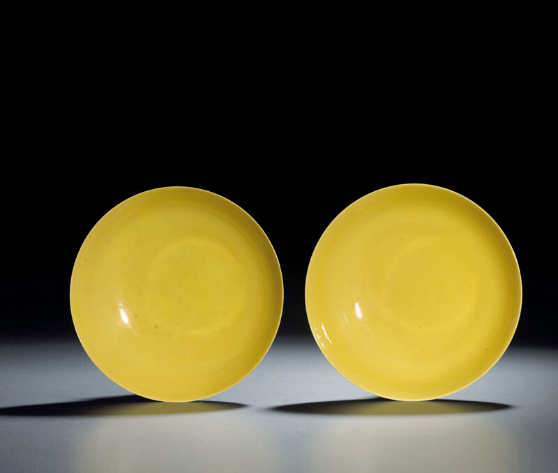 A fine pair of incised 'bajixiang' yellow-glazed dishes, Yongzheng six-character marks within double circles and of the period (1723-1735)