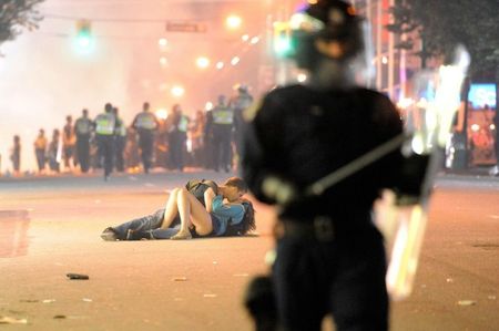 enhanced-buzz-wide-16942-1322857259-92 Australian Scott Jones kisses his Canadian girlfriend Alex Thomas after she was knocked to the ground by a police officer's riot shield in Vancouver, British Columbia
