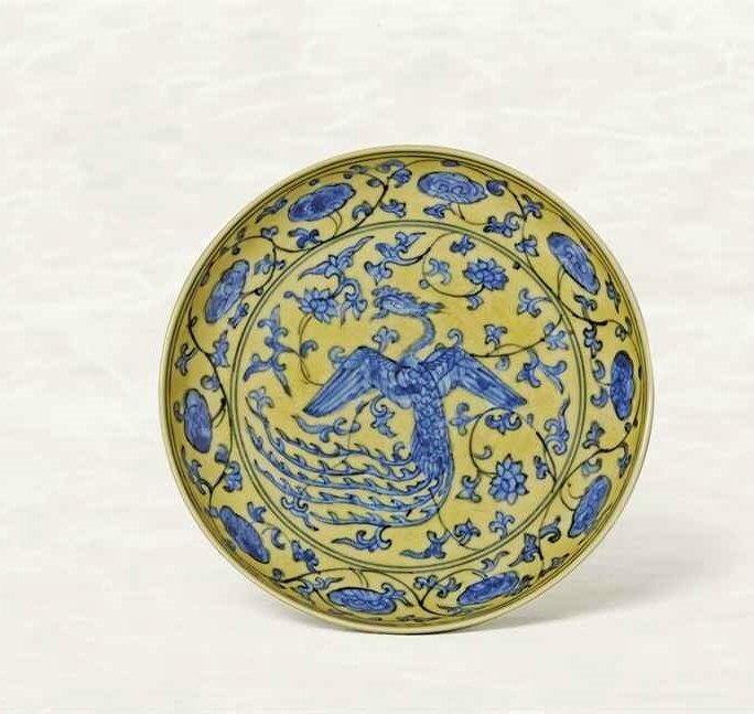 An exceptionally rare yellow-ground blue and white 'Phoenix' dish, Jiajing six-character mark within double circles and of the period (1522-1566)