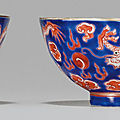A pair <b>of</b> iron-red <b>and</b> blue-enameled dragon cups, <b>Jiaqing</b> four-character <b>seal</b> <b>marks</b> in iron red <b>and</b> <b>of</b> <b>the</b> <b>period</b> (<b>1796</b>-<b>1820</b>)