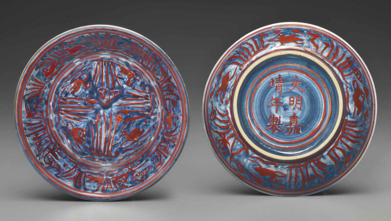 A very rare pair of small iron-red decorated blue and white dishes, Jiajing iron-red six-character marks within double-circles and of the period (1522-1566)