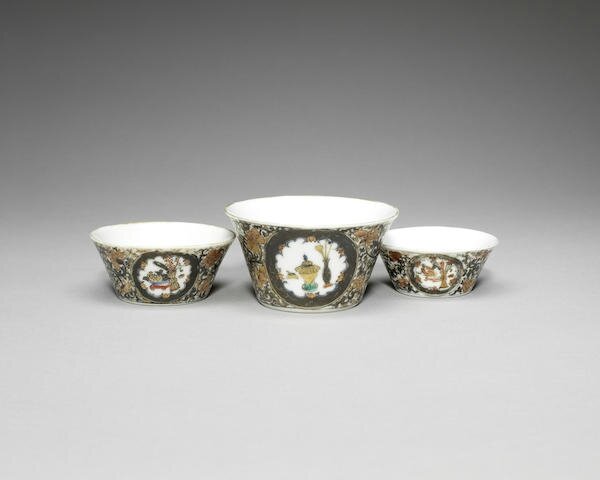 A rare part-set of grisaille enamelled and gilt nesting tea cups, Yongzheng six-character mark and of the period (1723-1735)