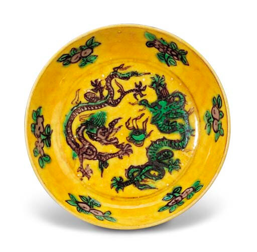 A very rare late Ming yellow-ground green and aubergine 'dragon' saucer, Wanli six-character mark and of the period (1573-1619)