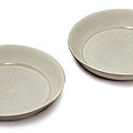 A pair of small carved 'Ding' '<b>daylily</b>' dishes, Northern Song dynasty