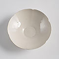 A fine light cream glazed <b>blossom</b>-<b>shaped</b> Ding <b>bowl</b>, Song dynasty (960-1279)