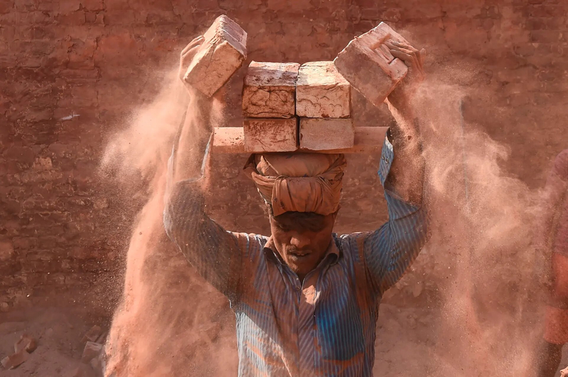 Savar, Bangladesh A man carries bricks in the outskirts of Dhaka Photograph Munir Uz Zaman