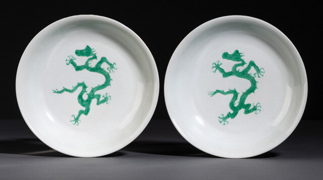 A rare pair of green-enamelled dragon anhua wave dishes, underglaze blue Hongzhi six-character marks and probably of the period